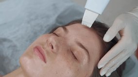 Video of cosmetician using ultrasonic device for cleaning face in a beauty salon
