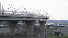 Side view of western high-speed diameter with bridge standing above empty parking in Saint Petersburg city, Russia. Cloudy sky. Real time video. Urban architecture theme.