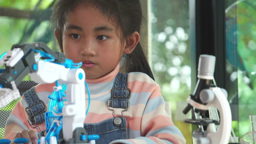 Girl control robot arm in high school