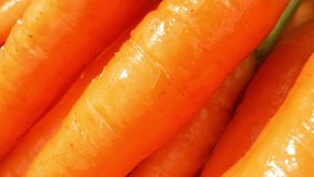 Baby carrots are typically small, slender, and cylindrical in shape. They are much smaller than regular full-grown carrots and are usually around 2 to 4 inches in length. Vibrant orange color. 4K
