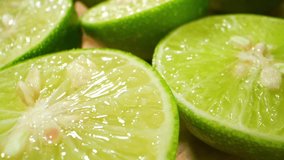 Macro video: Half green lemons glisten under soft light, showcasing their vibrant hues and succulent texture. Nature's refreshing beauty captured up close.  - Powered by Shutterstock - Get 15% off with code: PIKWIZARD15