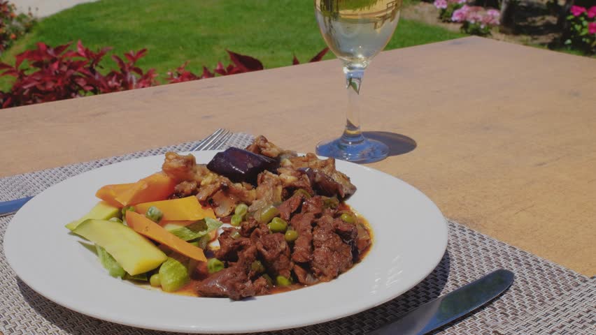 Delicious beef meat with grill vegetables on a white plate.