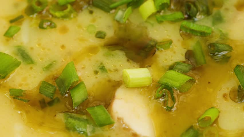 Bean soup with green onion close-up rotating. Arabian cuisine. Traditional middle eastern culture. Vegetarian homemade food concept, healthy eating. 