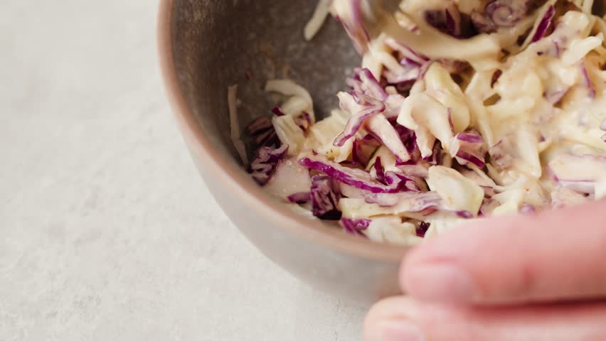 Chef cooking coleslaw, german Coleslaw salad made of freshly shredded white cabbage and grated carrot with homemade mayonnaise based salad dressing in wooden bowl. Royalty-Free Stock Footage #1107185269