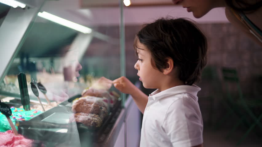 Child at Ice-Cream Parlor, Pointing Finger to Pick Flavor Behind Counter