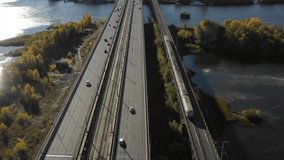 Aerial drone video of a bridge. Modern automobile and old railway bridges in Kiev. Kyiv, Ukraine. Dramatic colorful sunset over Dnipro river. Historical sights of Ukraine. Beautiful scenic view 