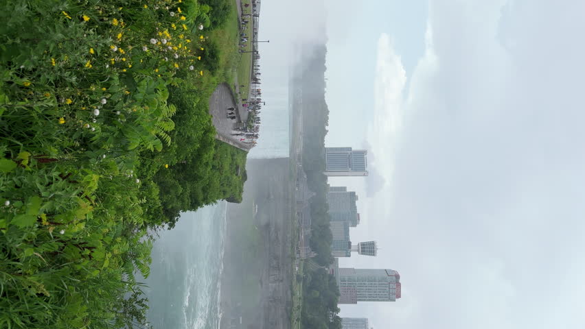 Quay at the Niagara river near the Niagara waterfall. A lot of tourists came to visit the Niagara fall. Canadian Ontario is on the other bank of the river, view of buildings and green trees