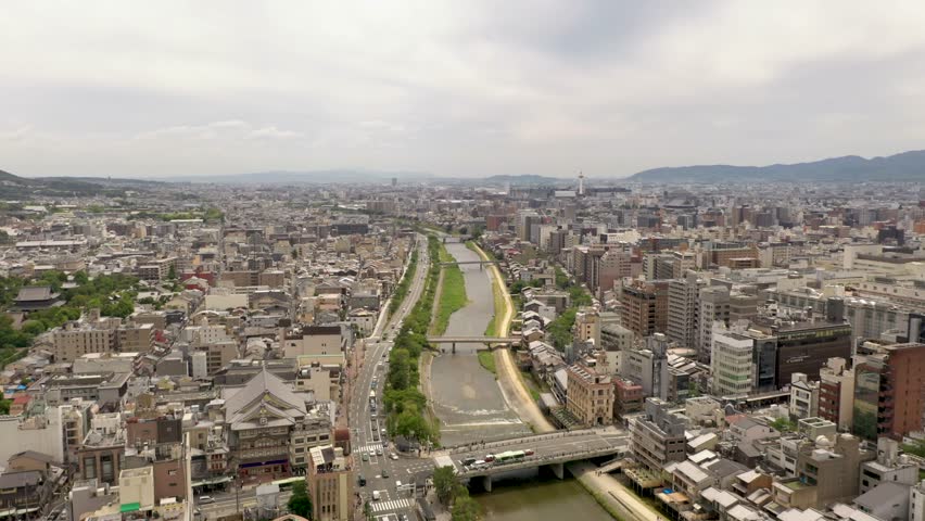Colorful wide aerial of Kyoto with Kamo river, temples, mountains, and city skyline in Kyoto, Japan.