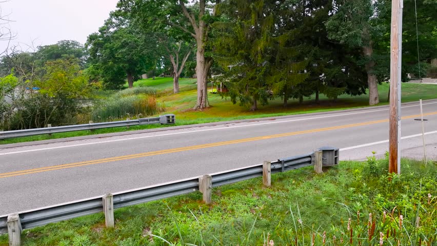 Drone clip of old school road barriers against a low point.