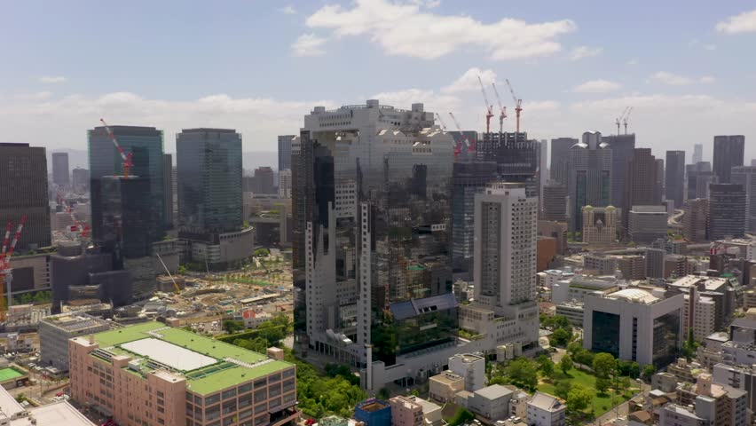Amazing wide aerial of Osaka landmark Umeda Sky Building with skyline, skyscrapers, and city in Osaka, Japan.