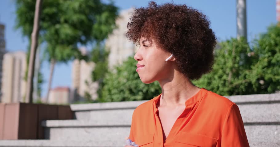 young african american hydrating replenishing water balance drinking water from a bottle at sunny day in city outdoor
