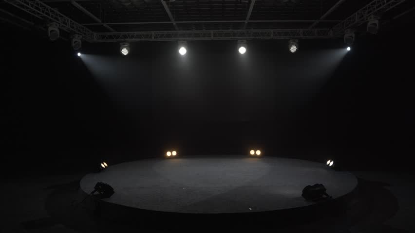 Professional lighting devices, lighting equipment on the round stage. Checking the lighting lights during the tests before the concert.