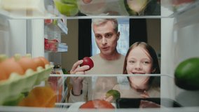 Adult Man and Girl Open Fridge with Organic Food of Fruits and Vegetables and Take Ingredients to Eat. Kitchen Refrigerator of Healthy Family Cooking Meal. POV Freezer Filled with Convenience Supply - Powered by Shutterstock - Get 15% off with code: PIKWIZARD15