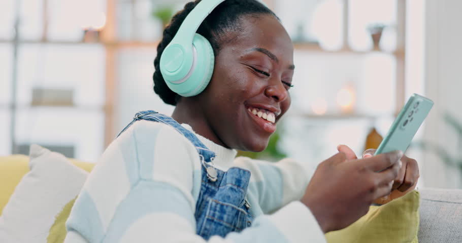 Cellphone, music and happy black woman dance, listen and streaming audio sound, radio or watch video. Phone, energy and African person search online for subscription podcast, playlist or song at home Royalty-Free Stock Footage #1107199899
