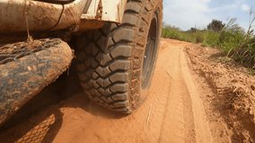 Point of view running on a dirt road. Off-road truck car wheels move on the dirty road with dust, wet and dry mud. Point of view travel in the backcountry place - Powered by Shutterstock - Get 15% off with code: PIKWIZARD15