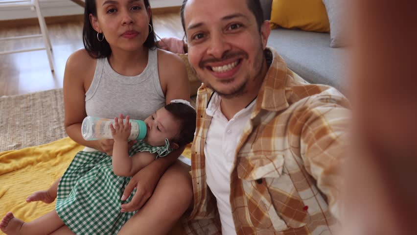dad and mom with their baby and a medical kit at home healing wound