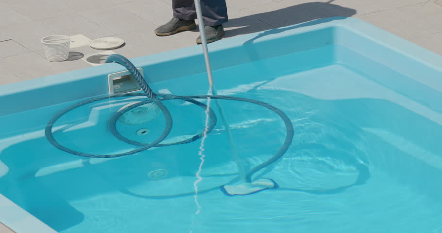 Vacuum cleaner for cleaning the pool. A worker removes pollution from the bottom of the pool, close-up Royalty-Free Stock Footage #1107200741