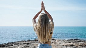 Young blonde woman doing yoga exercise backwards at seaside - Powered by Shutterstock - Get 15% off with code: PIKWIZARD15