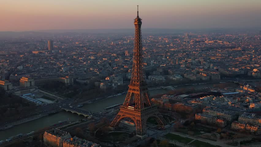 The drone is going around the eiffel tower during golden hour at daytime in Paris France Aerial Footage 4K Royalty-Free Stock Footage #1107204159
