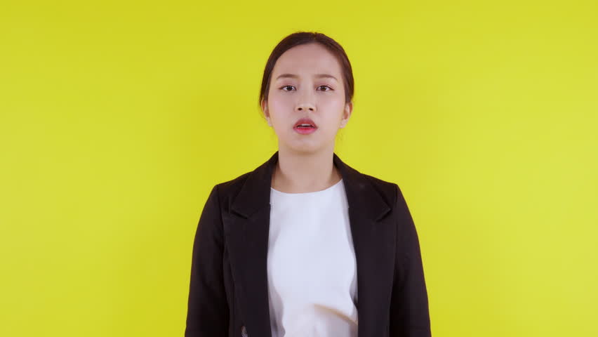 Portrait young asian businesswoman unhappy and angry on yellow background, expression and emotion, business woman annoyed and worried, aggressive and anxiety, female stress and depressed. Royalty-Free Stock Footage #1107211535