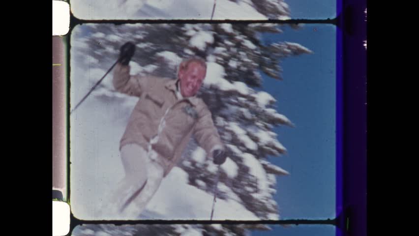 1985 Vail, CO. Man with blond hair and big smile skis in deep powder snow. Ultra slow motion footage reveals ecstatic nature of happy man. 4K Overscan of vintage archival film