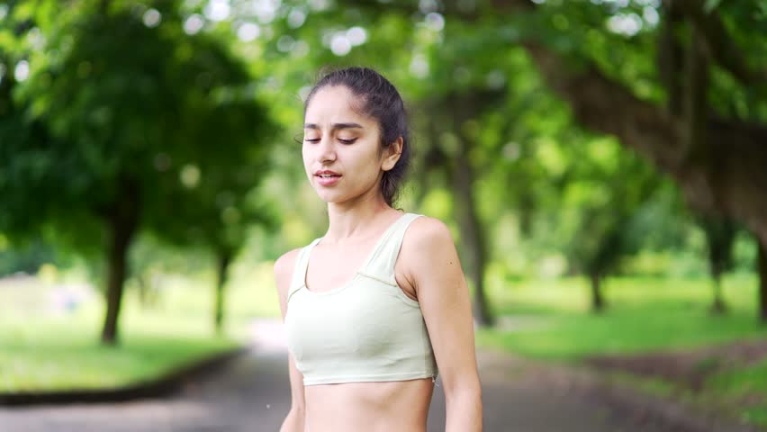 Young athletic woman sharp pain in her shoulder during a morning jog workout in urban city park. A sad female girl was injured. Unfortunate athlete rubs and massages the muscles on the sore sport Royalty-Free Stock Footage #1107213543