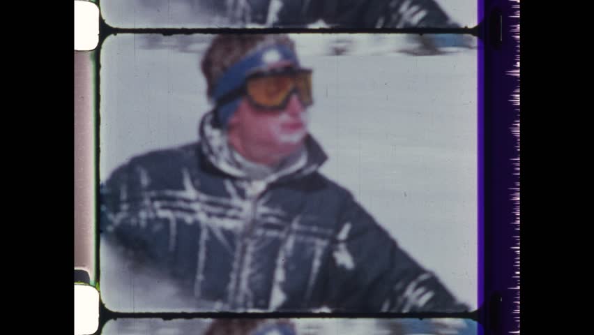 1988 Les Portes du Soleil, France. Man skiing in deep powder snow. Slow motion footage of skier freestyle carving in non piste snow. Ski googles protect eyes. 4K Overscan of vintage archival film 