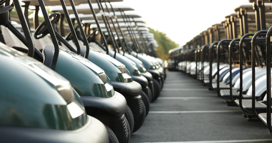 Many golf carts for golf player on a golf course. golf course carts cars at luxury resort sport venue in neat line row. Royalty-Free Stock Footage #1107214289