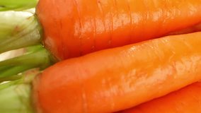 Baby carrots, popular since the 1980s, emerged when farmer Mike Yurosek transformed imperfect carrots into smooth, appealing shapes using a cutter. Macro video. Food and vegetable concept. 4K
