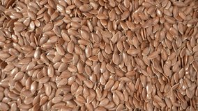 The combination of high fiber content and healthy fats in flax seeds can promote feelings of fullness, potentially assisting in weight management and controlling appetite. Macro footage. Food concept
