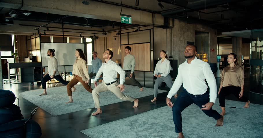 The international team does yoga during the break between work in the office. Oyise workers keep their body and mind in fine Royalty-Free Stock Footage #1107223737