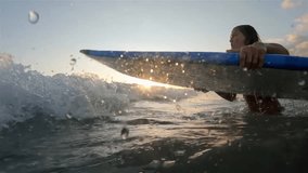 Surfing at Sunset. Outdoor Active Lifestyle. Portrait of surfer woman surfing having fun on Bali, Indonesia. Female bikini girl in water during surfing surfboard smiling happy living healthy lifestyle - Powered by Shutterstock - Get 15% off with code: PIKWIZARD15