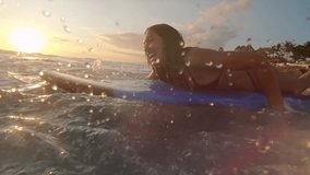 Surfing at Sunset. Outdoor Active Lifestyle. Portrait of surfer woman surfing having fun on Bali, Indonesia. Female bikini girl in water during surfing surfboard smiling happy living healthy lifestyle - Powered by Shutterstock - Get 15% off with code: PIKWIZARD15