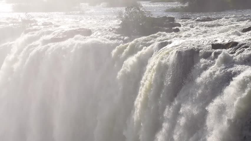 Slow motion shot of the amazing Victoria Falls on the Zambezi River at the border of Zambia and Zimbabwe. Royalty-Free Stock Footage #1107225853