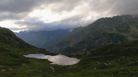 4K time lapse of a mountain lake in the Swiss Alps on a cloudy day.