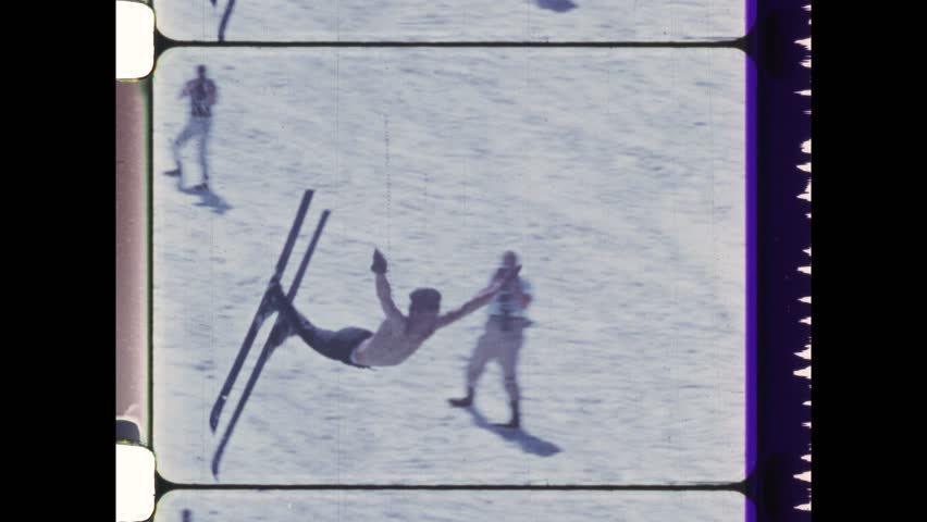 1982 Vail, CO. Stunt Man performs front flip on snow skis. Daredevil skier flipping into icy cold water at bottom of ski slope. 4K Overscan of vintage archival film