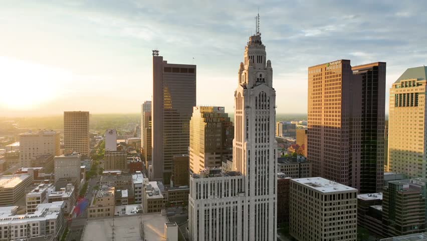 Aerial video close up of main Columbus skyscrapers with sunrise hitting side of buildings