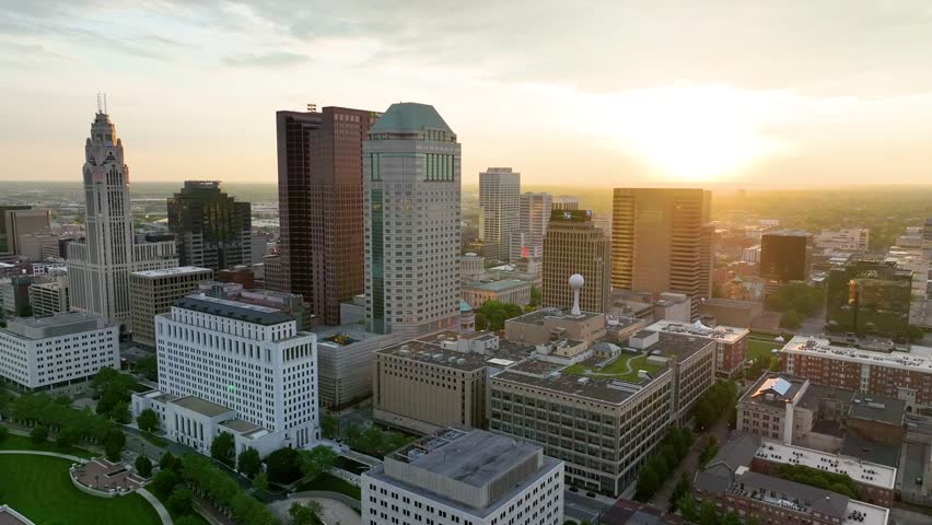 Aerial video main skyscrapers Columbus Ohio view with river and bridge at sunrise