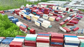 Aerial video of large shipping yard with multiple colors of shipping containers