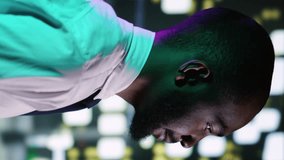 Vertical video Businessman admiring skyscrapers at night, walking around city center with streetlights. African american person feeling happy on urban downtown promenade, relaxing on sidewalk - Powered by Shutterstock - Get 15% off with code: PIKWIZARD15