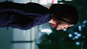 Vertical video Asian woman strolling around city on sidewalk, enjoying urban promenade under streetlamps. Confident person walking at nighttime, admiring town landscapes and skyscrapers. Handheld shot - Powered by Shutterstock - Get 15% off with code: PIKWIZARD15
