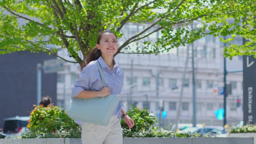 Japanese business woman running with a smile