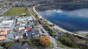 Wanaka, New Zealand: Aerial drone footage of the famous Wanaka tourist town by Lake Wanaka in Otago province in New Zealand south island in winter. Shot with a tilt up motion