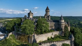 Medieval castle in Braunfels, Hesse, Germany, with many later additions. Aerial 4K revealing video in summer in sunset light.
