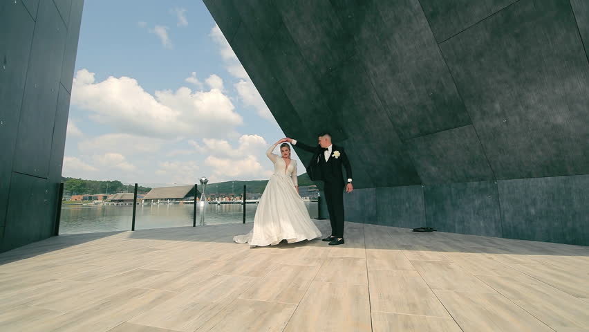 Wedding dance of the bride and groom. The groom and the bride dance a wedding dance near the lake