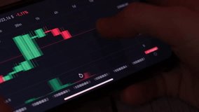 Investment stockbroker analysis data graph with price rates. Crypto trader investor broker holding using smartphone app analyzing financial data stock market on cell phone, checking online trading - Powered by Shutterstock - Get 15% off with code: PIKWIZARD15