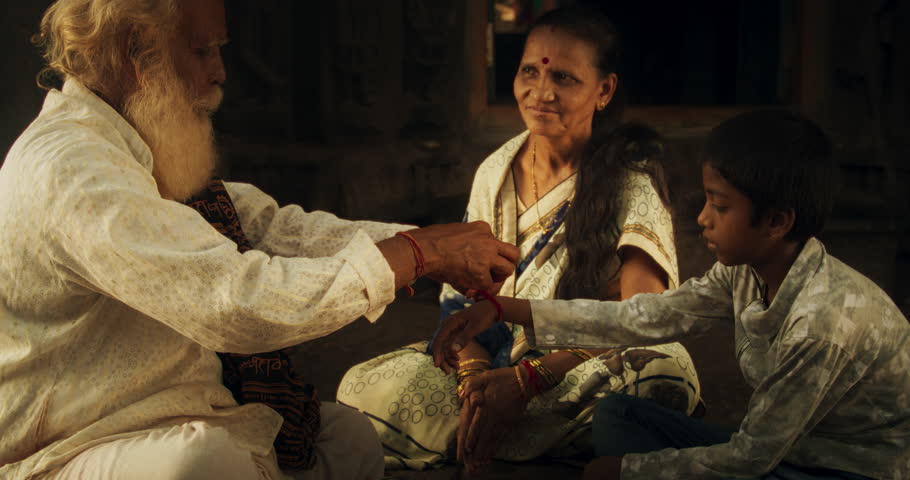 Authentic Footage of Hindu Priest Tying a Mauli Thread Around a Male Kid