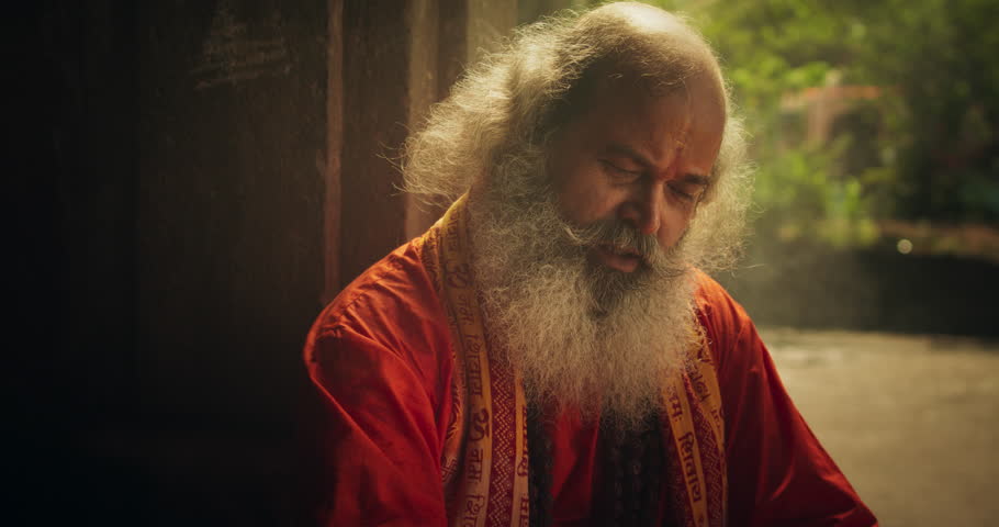 Slow Motion Close Up Portrait of Old Indian Monk Chanting in an Ancient Temple. Senior Guru Singing Religious Songs, Humble Male Devoted to Hinduism, Sharing Spiritual Wisdom and Love Through Worship Royalty-Free Stock Footage #1107248035