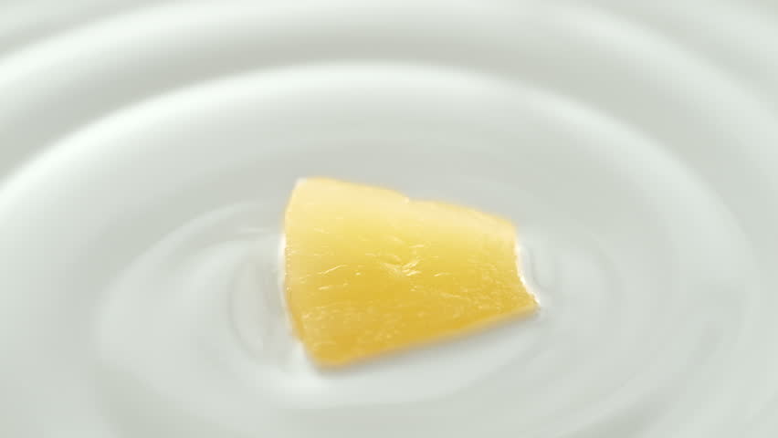 Pineapple Scooped with Silver Spoon from Creamy Thick Yogurt in Macro and Slow Motion