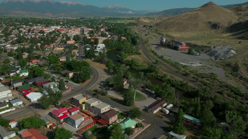Aerial cinematic drone mid summer downtown Salida S Colorado near Buena Vista on Arkansas River Riverside Park Scout surfing wave mountain biking hiking rafting Rocky Mountain forward pan up movement